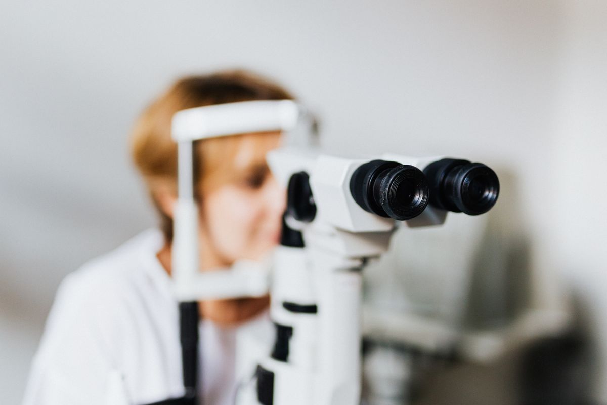 Ophthalmologist using precision eye examination equipment