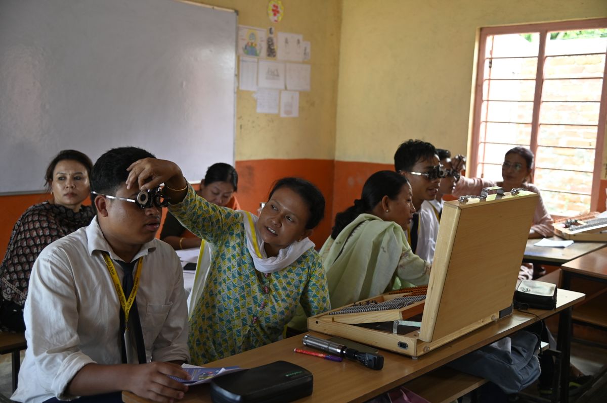 Indian students receiving vision screening in a classroom