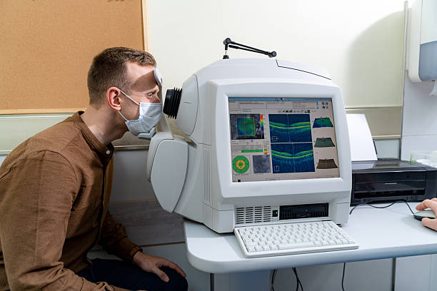 Patient undergoing corneal topography mapping on diagnostic equipment